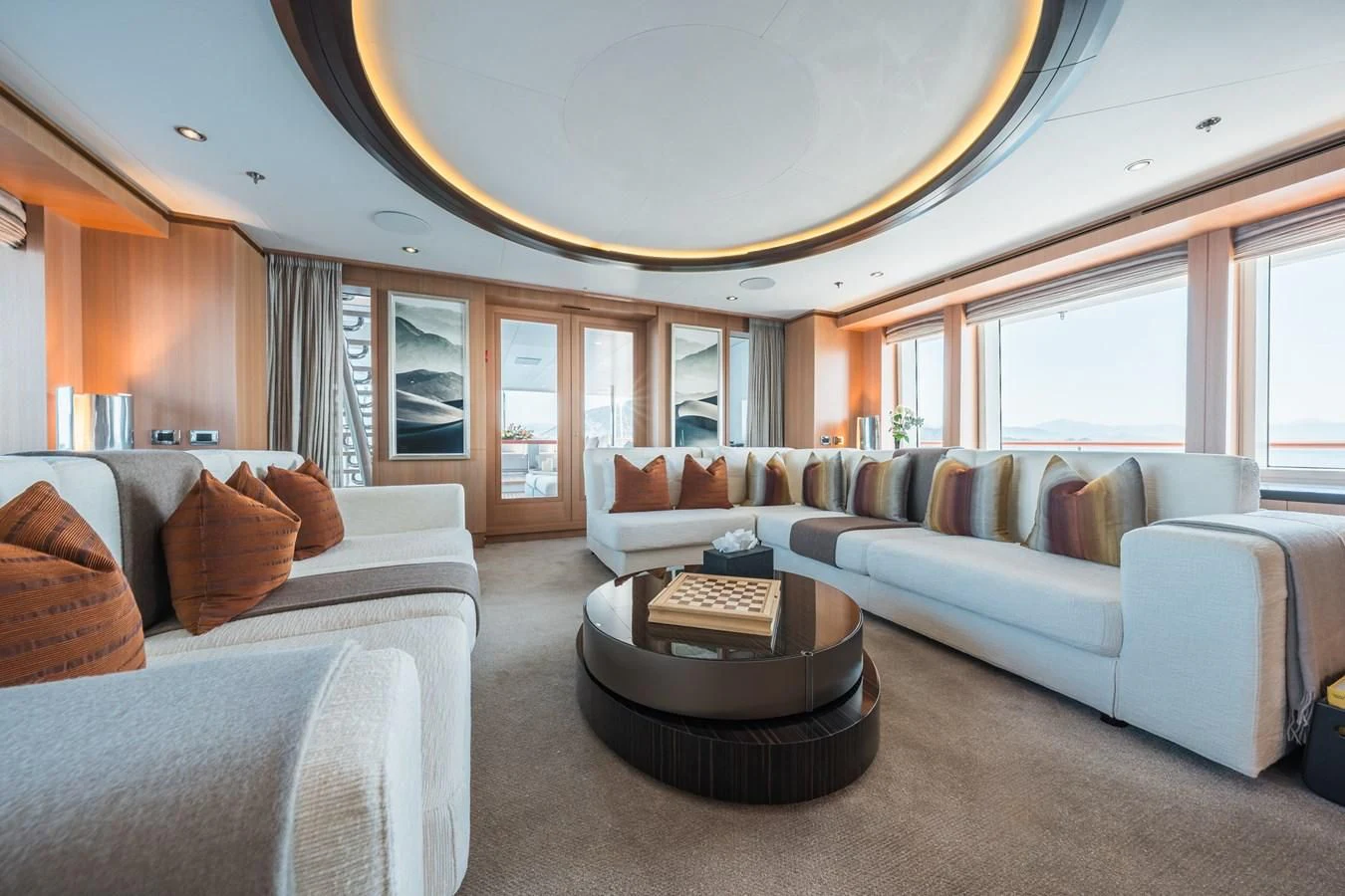 a living room with a large chandelier aboard GO Yacht for Sale