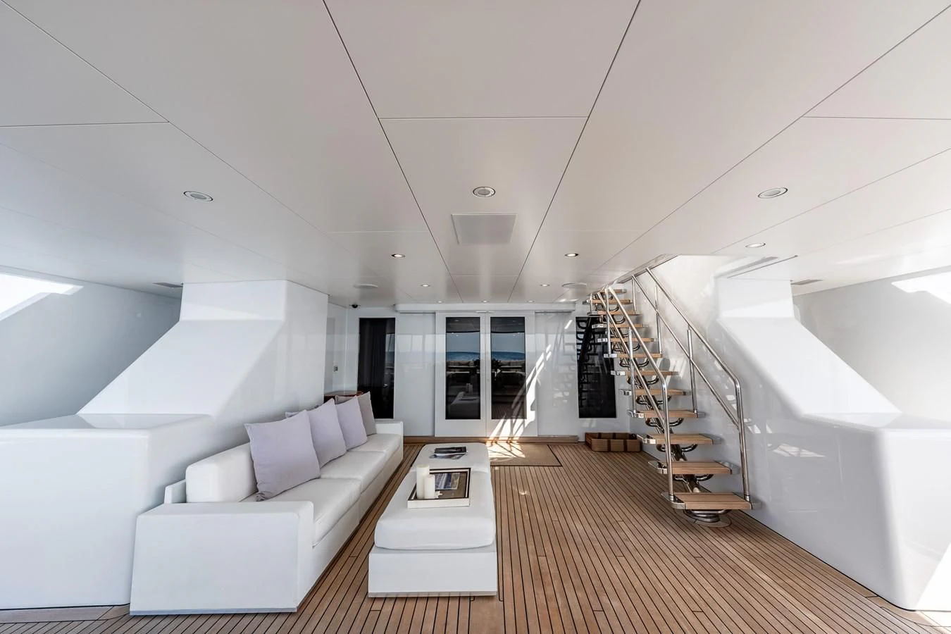 a room with a couch and a staircase aboard GO Yacht for Sale