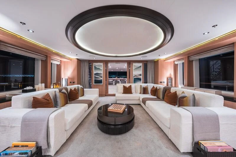 a living room with a large chandelier aboard GO Yacht for Sale