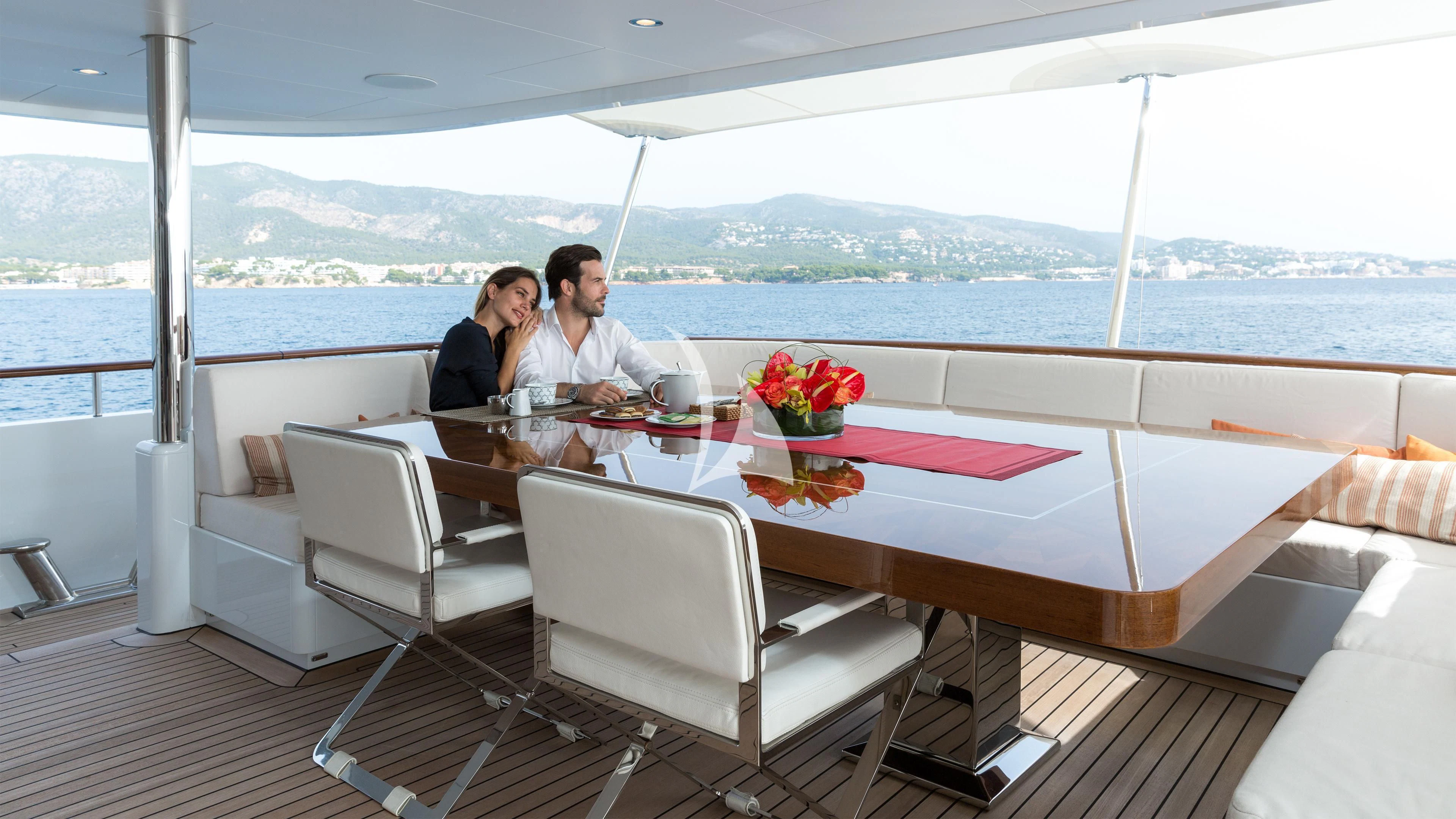 a couple sitting at a table aboard GO Yacht for Sale