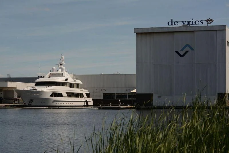 a large white boat in a harbor aboard GO Yacht for Sale