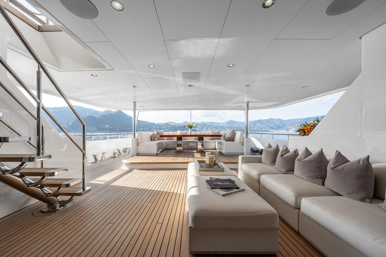 a room with a couch and a table and a large window aboard GO Yacht for Sale