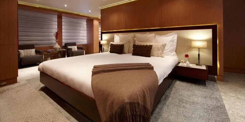 a large bed in a hotel room aboard GO Yacht for Sale