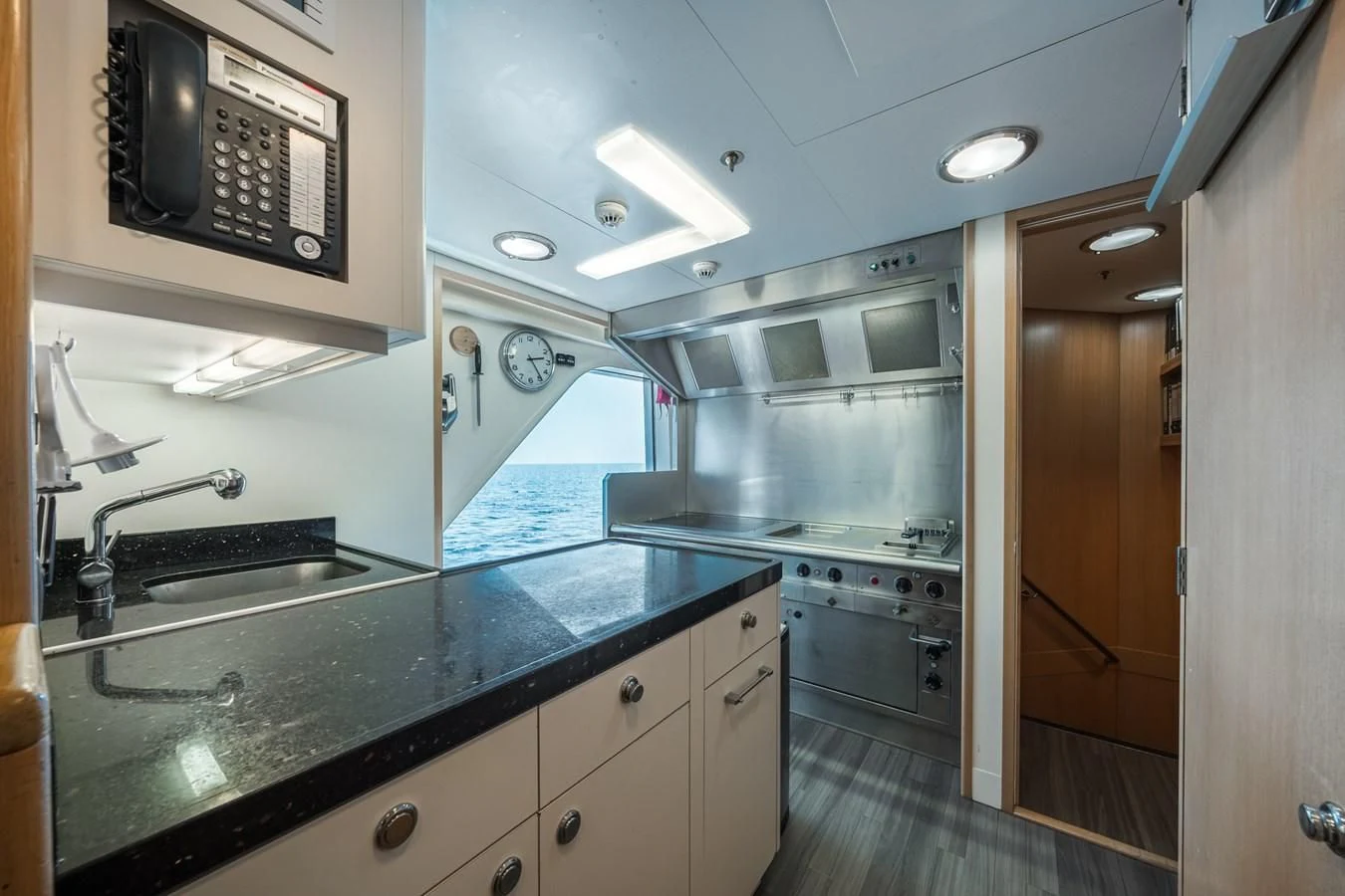 a kitchen with a black countertop aboard GO Yacht for Sale