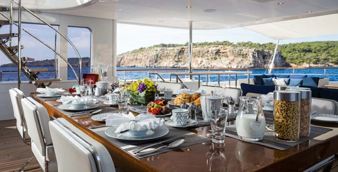 a table set with food and drinks aboard GO Yacht for Sale