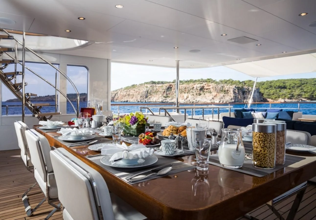 a table with plates and glasses on it aboard GO Yacht for Sale
