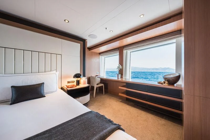 a bedroom with a large window aboard GO Yacht for Sale