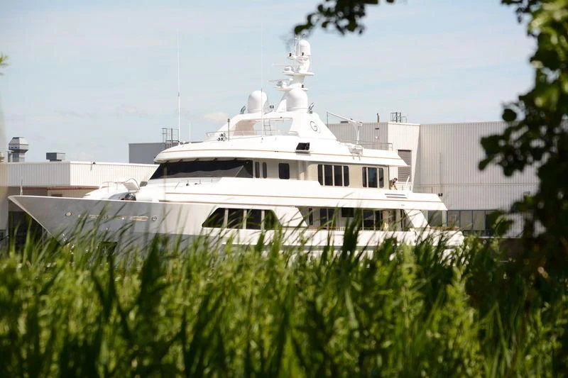 a large white boat in a yard aboard GO Yacht for Sale