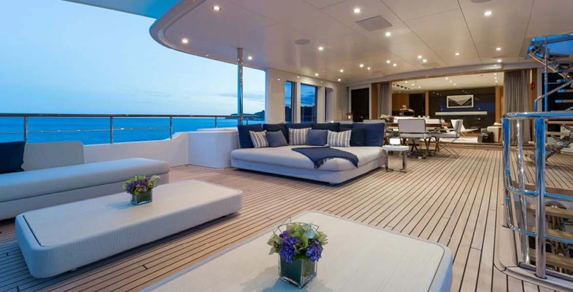 a large living room with a white couch and a table aboard GO Yacht for Sale