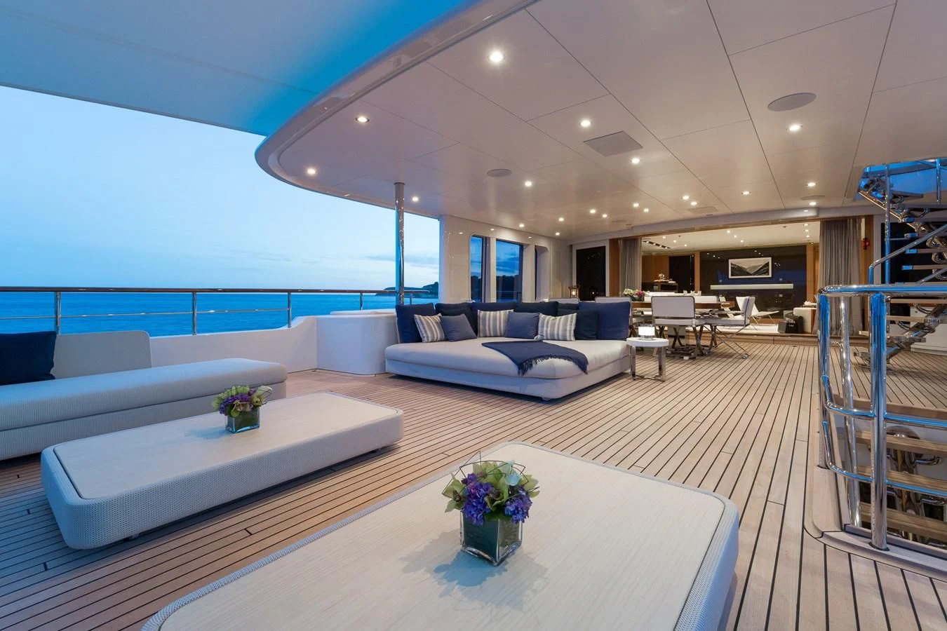 a modern living room with white couches and a table aboard GO Yacht for Sale