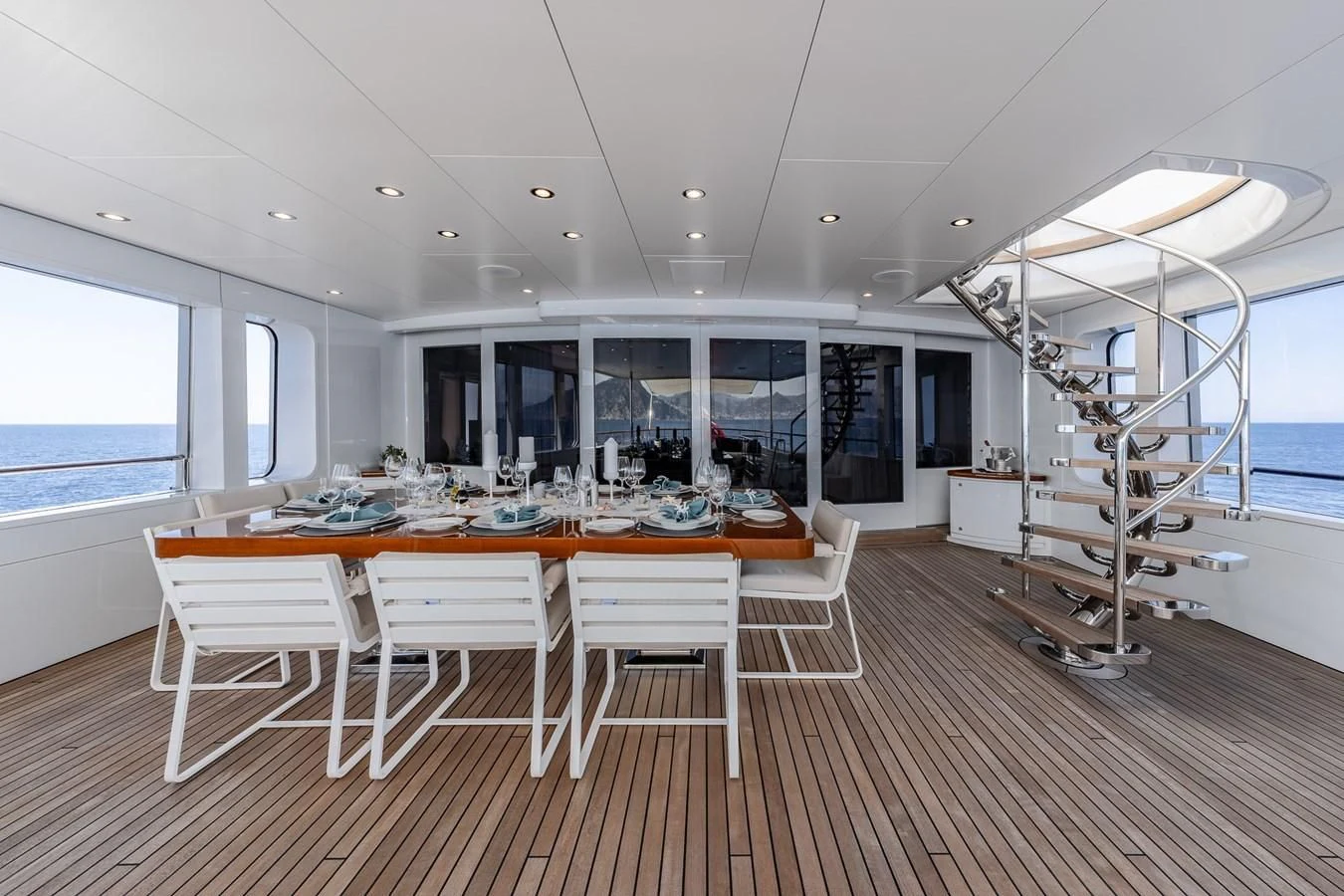 a large room with tables and chairs aboard GO Yacht for Sale