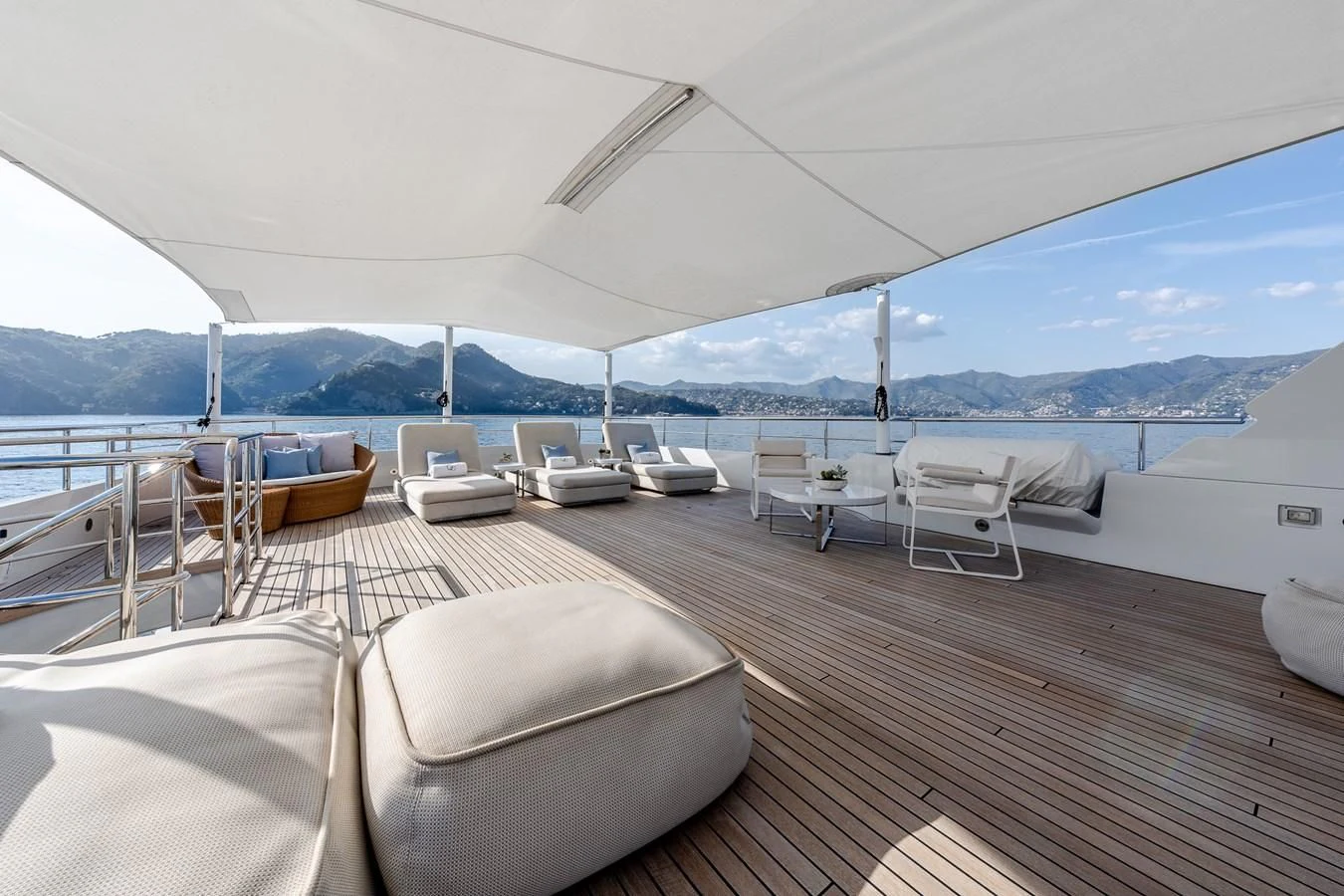 a deck with chairs and tables on it aboard GO Yacht for Sale