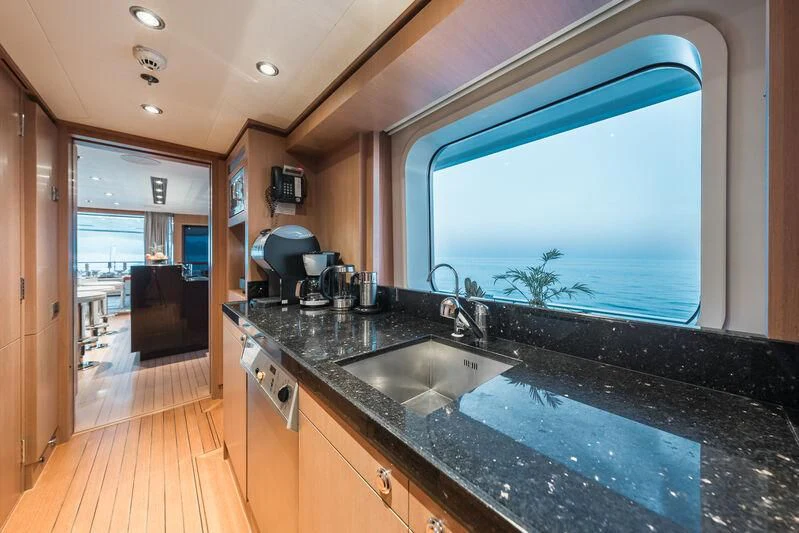 a kitchen with a large window aboard GO Yacht for Sale