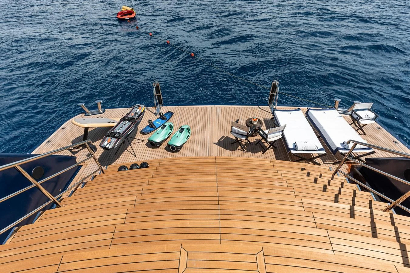 chairs and boats on a beach aboard FORCE BLUE Yacht for Charter