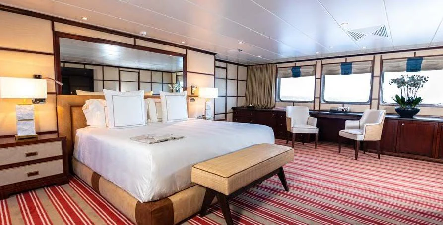 a hotel room with a bed and desk aboard FORCE BLUE Yacht for Charter