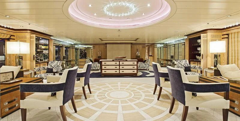 a room with a piano and chairs aboard FORCE BLUE Yacht for Charter