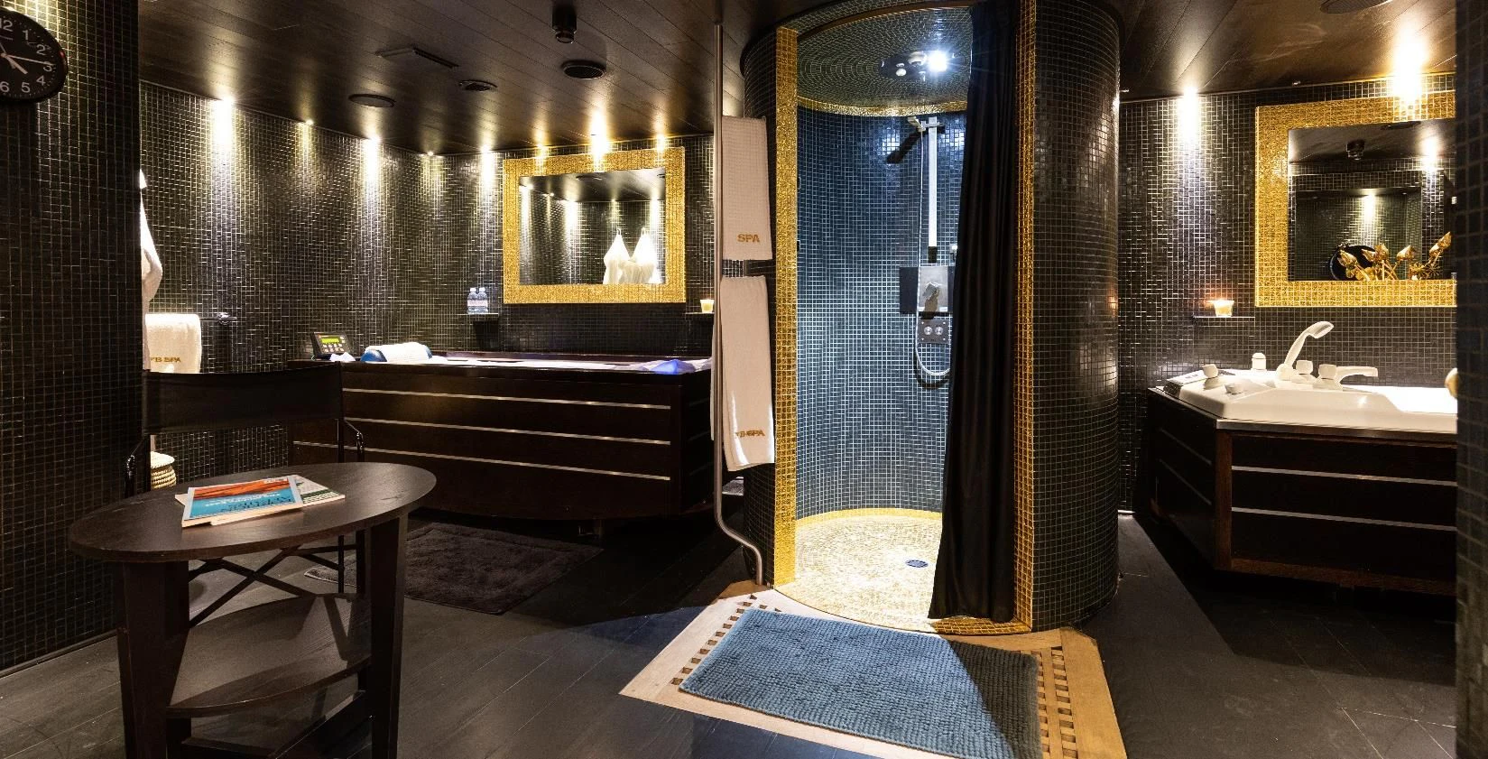 a bathroom with a shower curtain and a table aboard FORCE BLUE Yacht for Charter