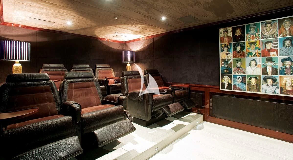 a room with leather couches and a table with a large screen aboard FORCE BLUE Yacht for Charter