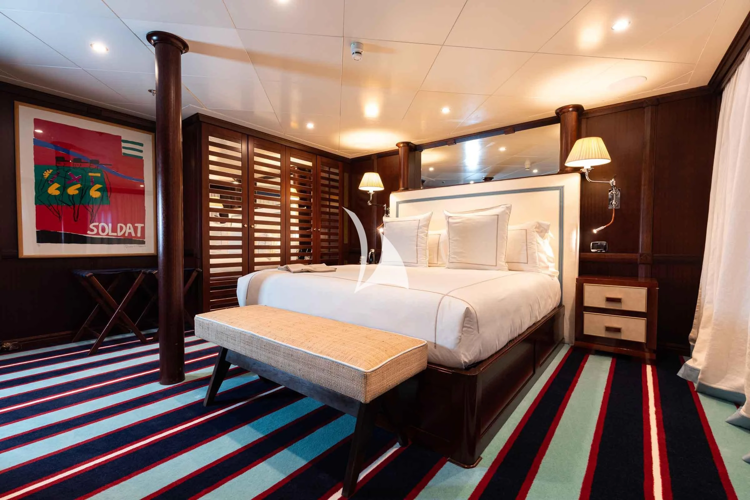 a room with a bed and a table aboard FORCE BLUE Yacht for Charter
