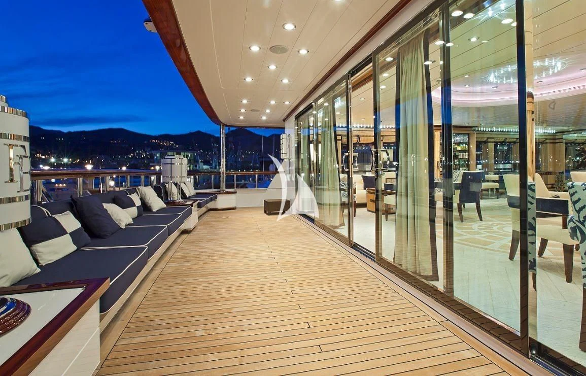 a room with a couch and a table and a view of a city aboard FORCE BLUE Yacht for Charter