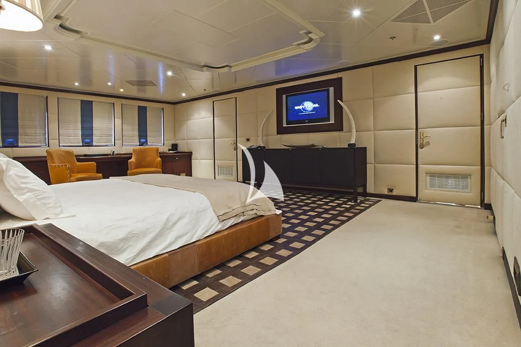 a room with beds and a tv aboard FORCE BLUE Yacht for Charter