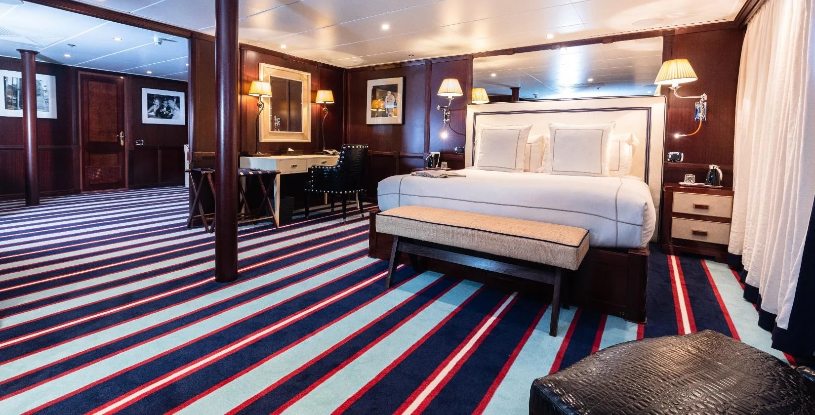 a hotel room with a bed and a table aboard FORCE BLUE Yacht for Charter