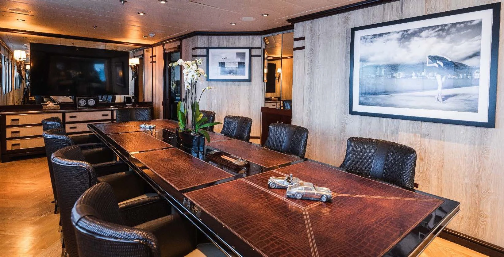 a large room with a table and chairs aboard FORCE BLUE Yacht for Charter