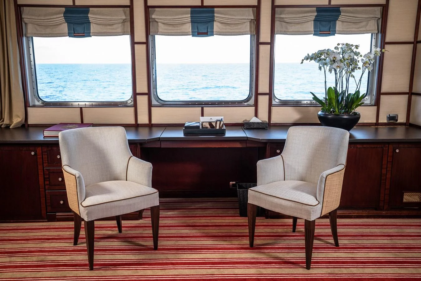 a couple of chairs sit in front of a window aboard FORCE BLUE Yacht for Charter
