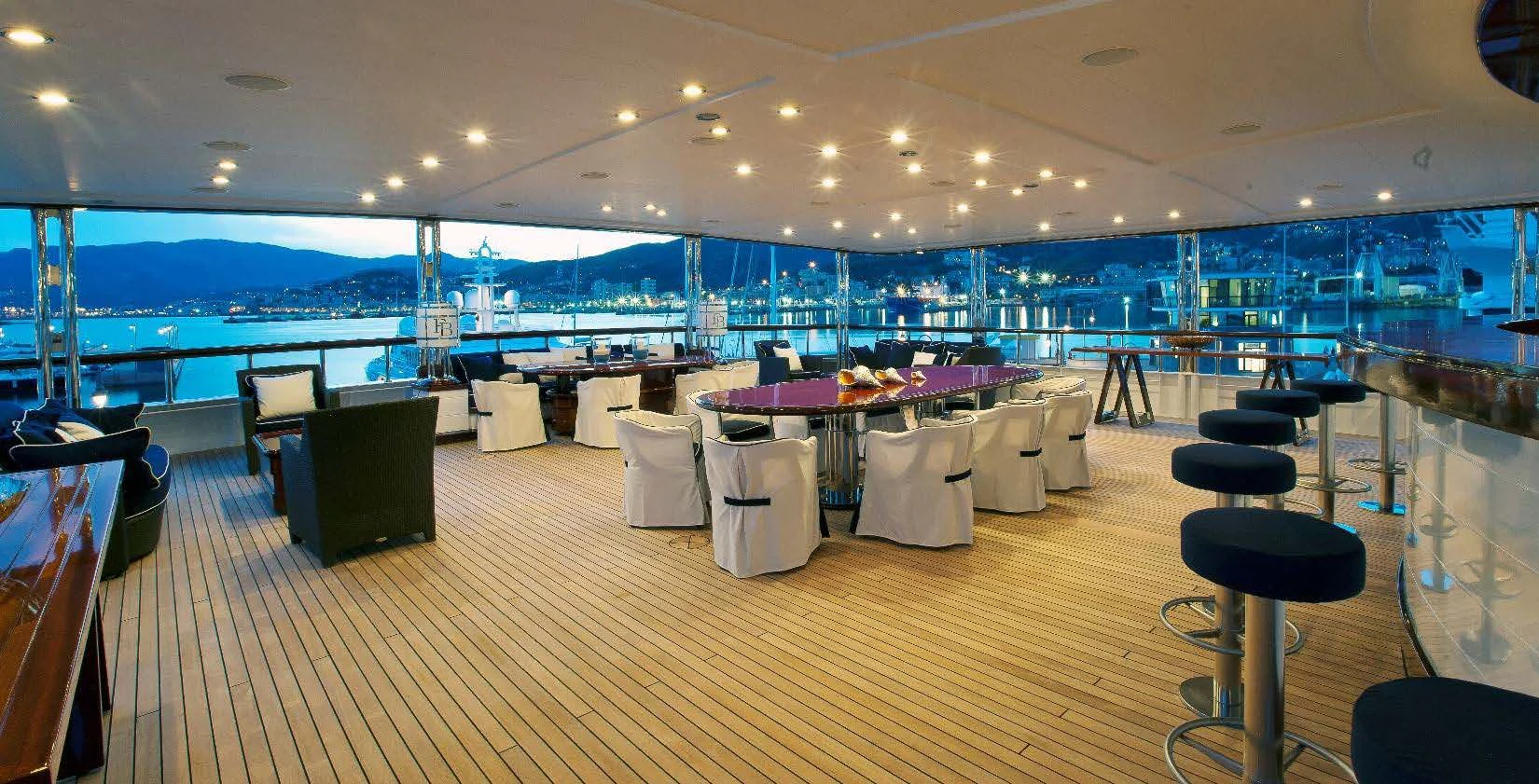 a room with tables and chairs aboard FORCE BLUE Yacht for Charter
