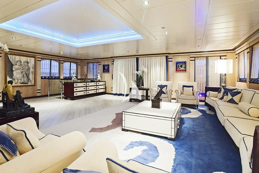 a large room with a large white bed and a large white table aboard FORCE BLUE Yacht for Charter