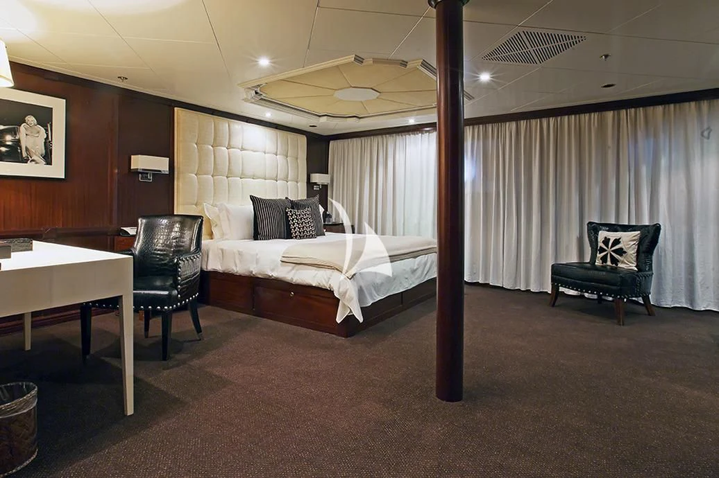 a hotel room with a bed and desk aboard FORCE BLUE Yacht for Charter