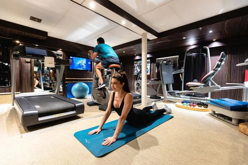 a person exercising in a gym aboard FORCE BLUE Yacht for Charter