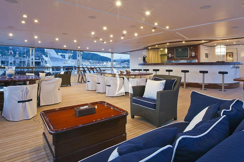 a room with a table chairs and a tv aboard FORCE BLUE Yacht for Charter