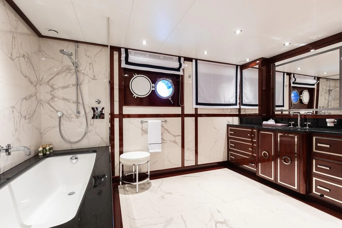 a bathroom with a tub sink and cabinets aboard FORCE BLUE Yacht for Charter