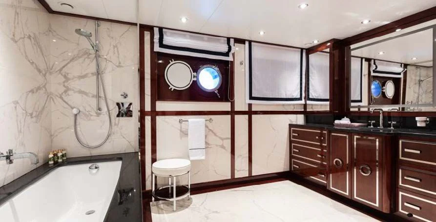 a bathroom with a tub sink and cabinets aboard FORCE BLUE Yacht for Charter