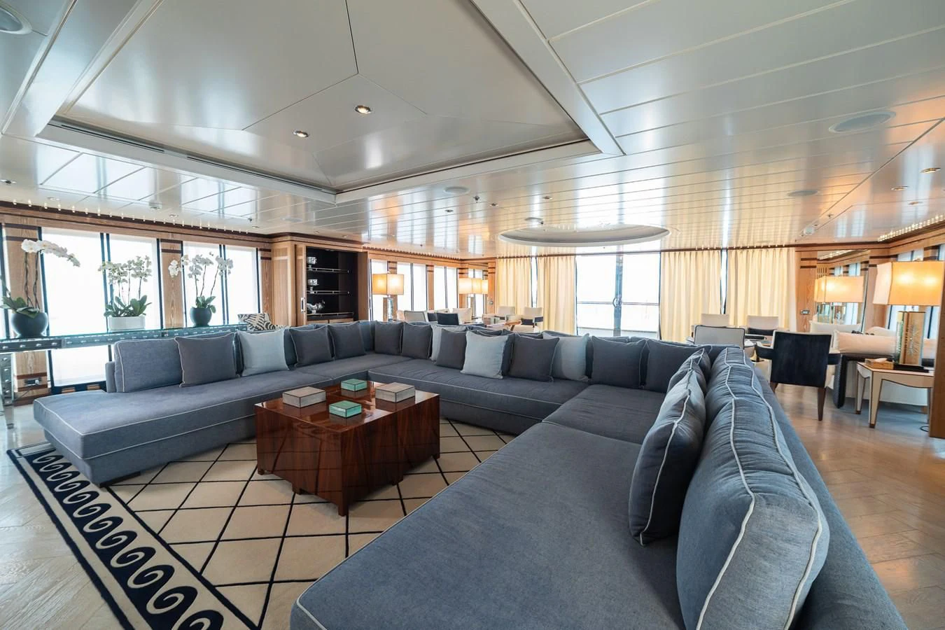 a large living room with a large sectional sofa and a coffee table aboard FORCE BLUE Yacht for Charter