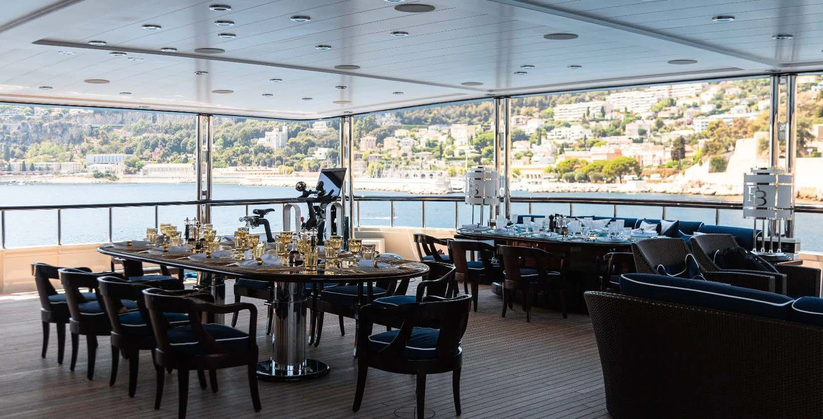 a room with tables and chairs aboard FORCE BLUE Yacht for Charter