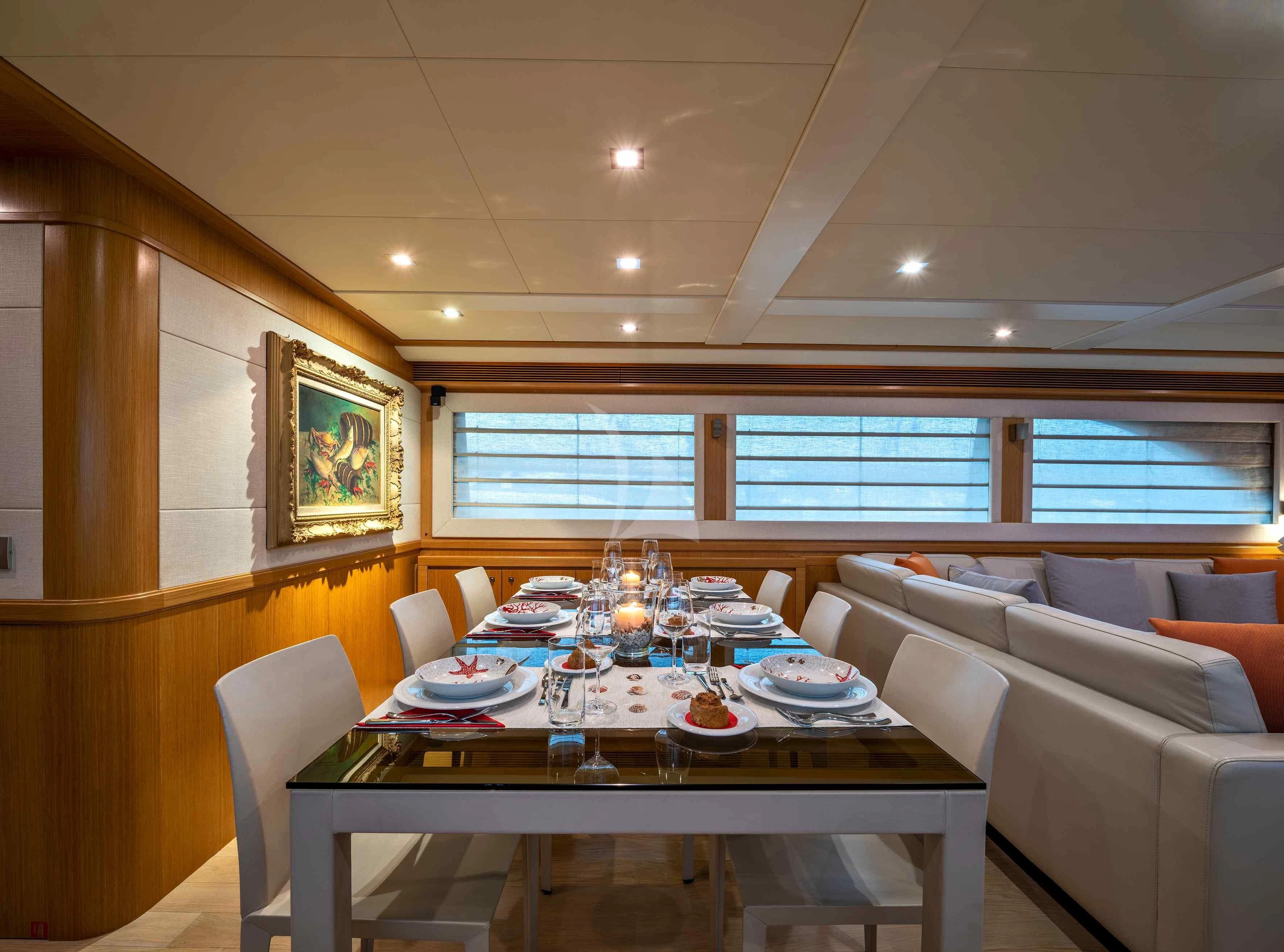 a dining room with a table set aboard EOLIA Yacht for Sale