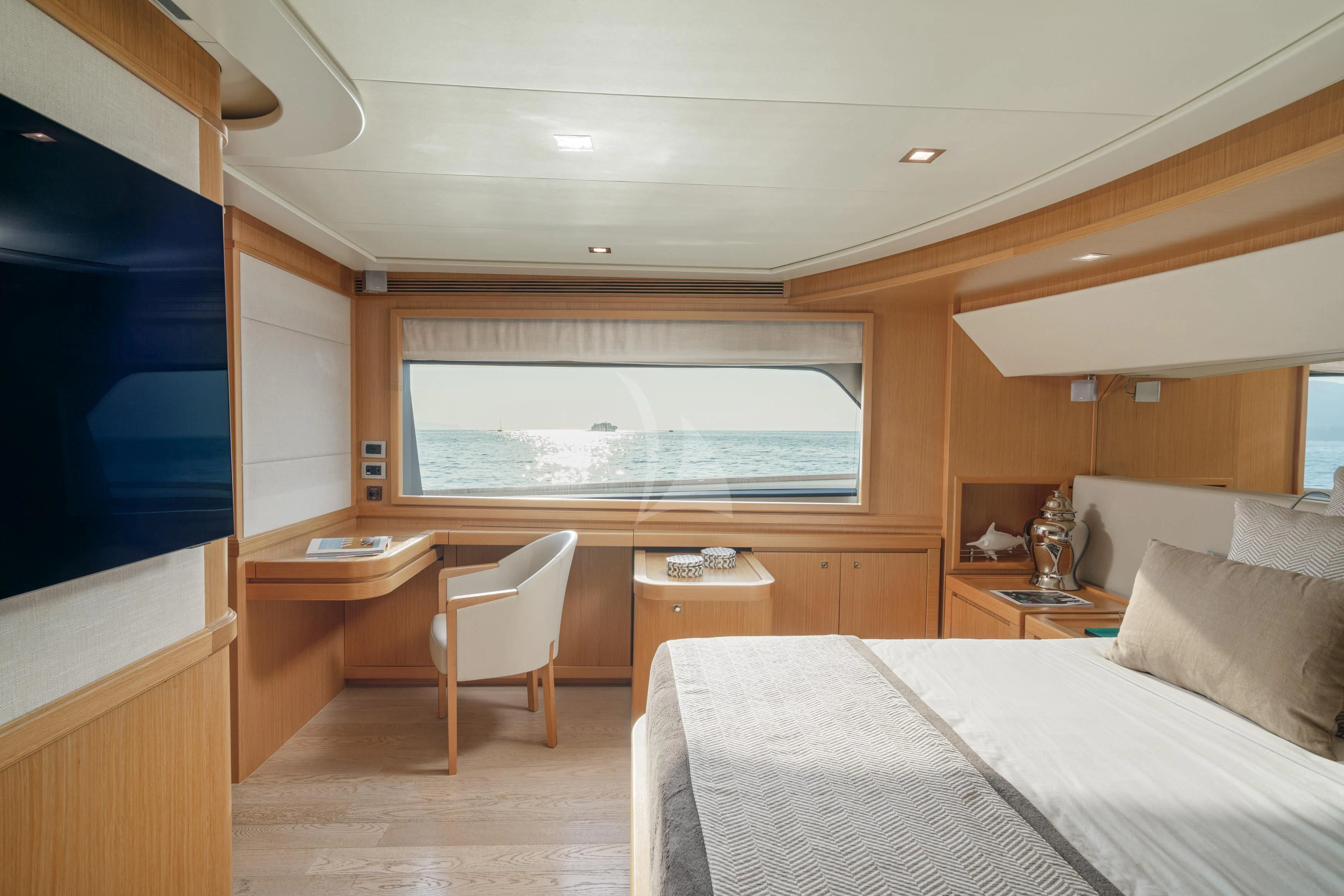 a bedroom with a bed and desk aboard EOLIA Yacht for Sale