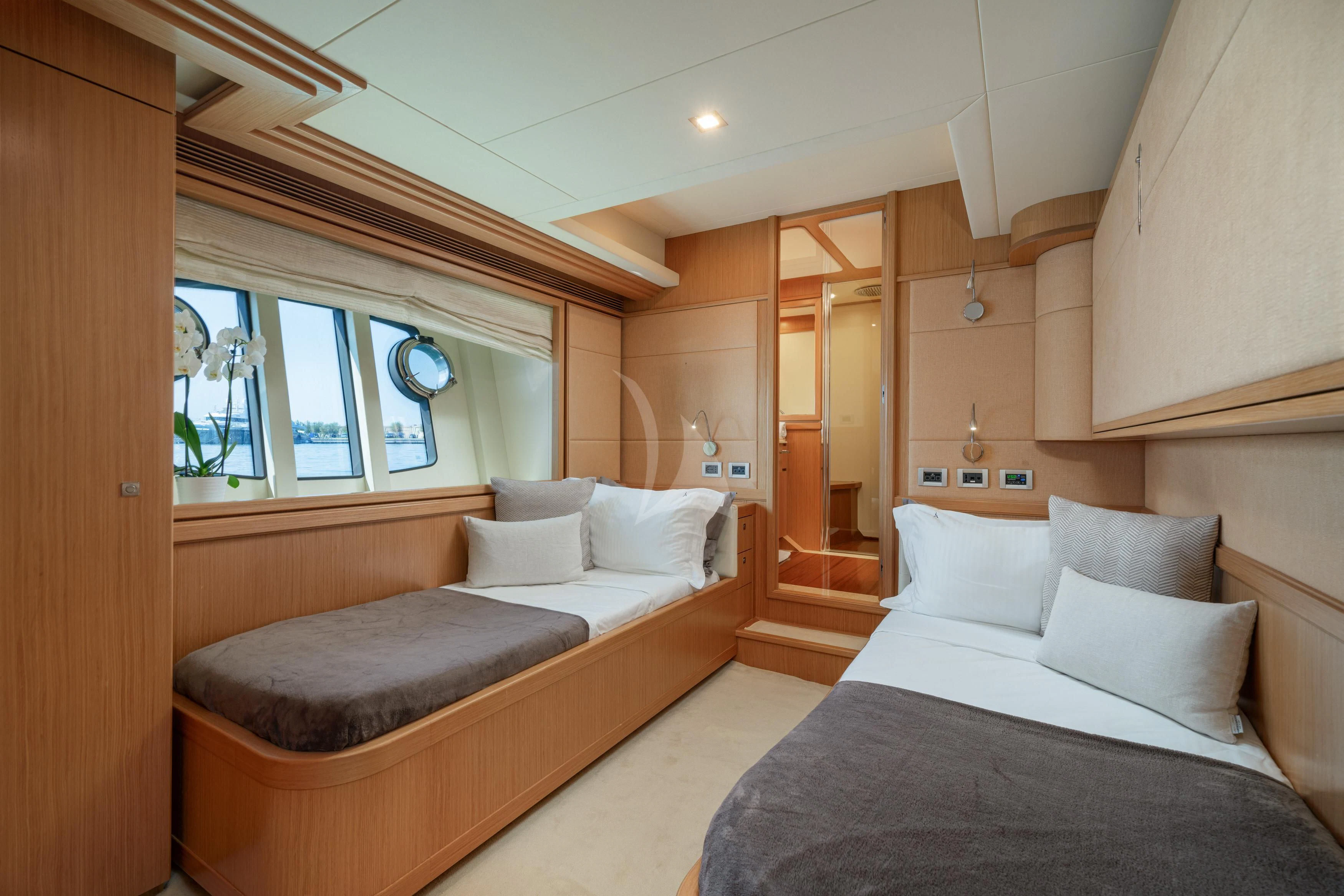 a room with a bed and a couch aboard EOLIA Yacht for Sale