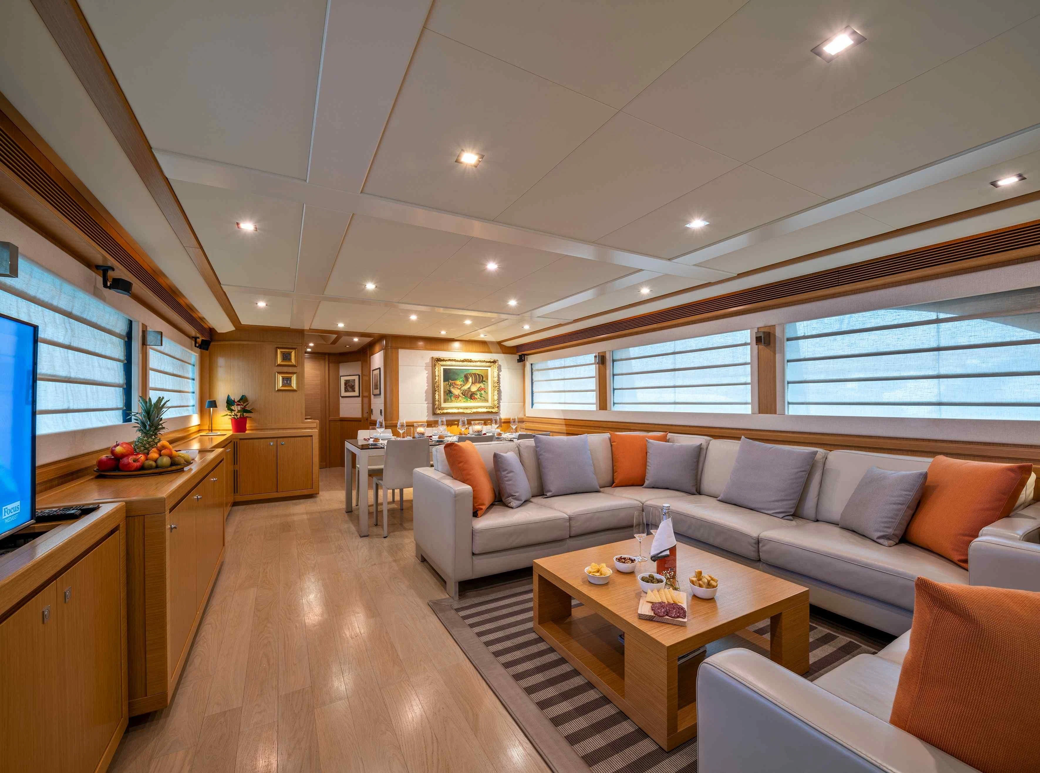 a living room with a couch and a table aboard EOLIA Yacht for Sale