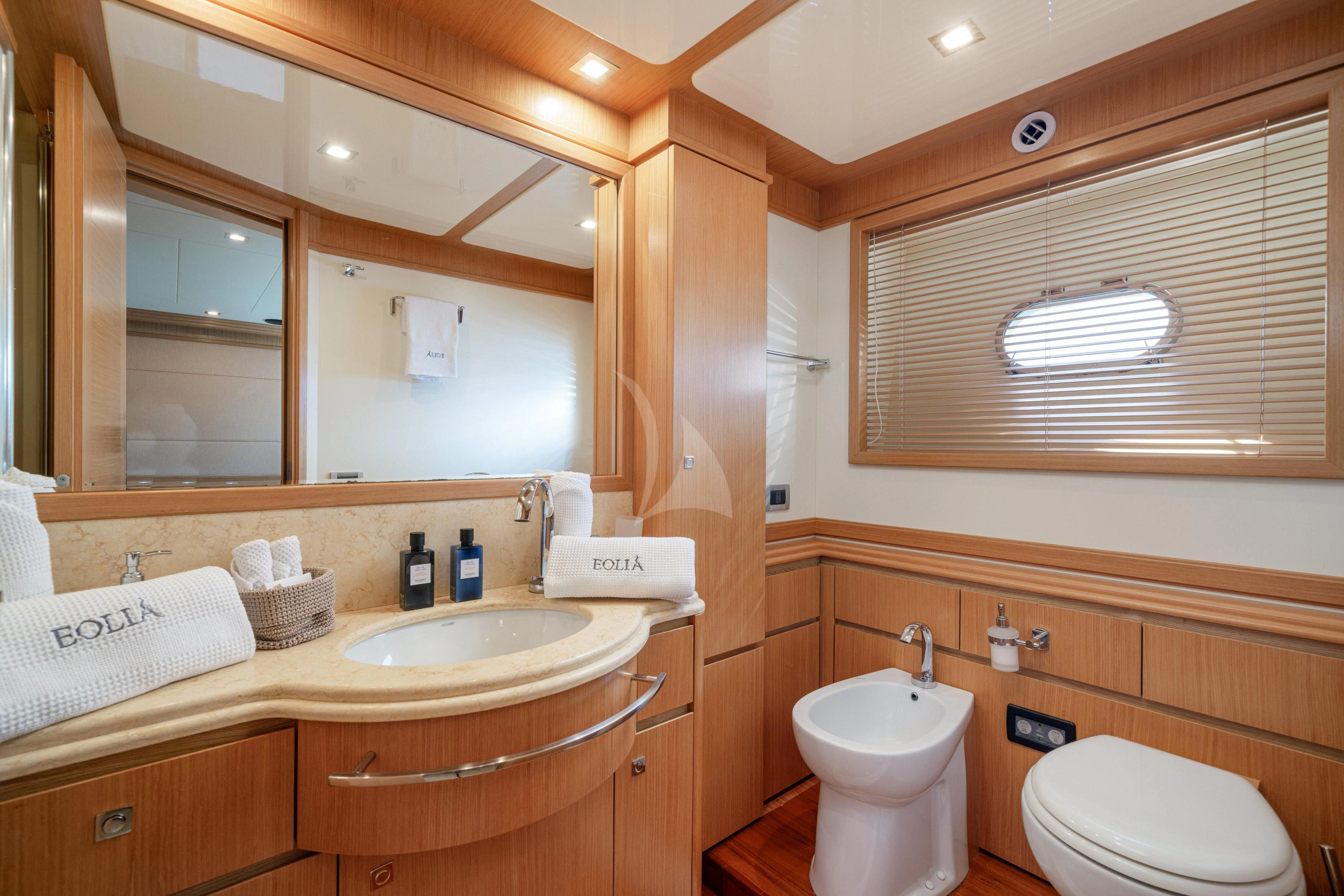 a bathroom with a sink toilet and a mirror aboard EOLIA Yacht for Sale