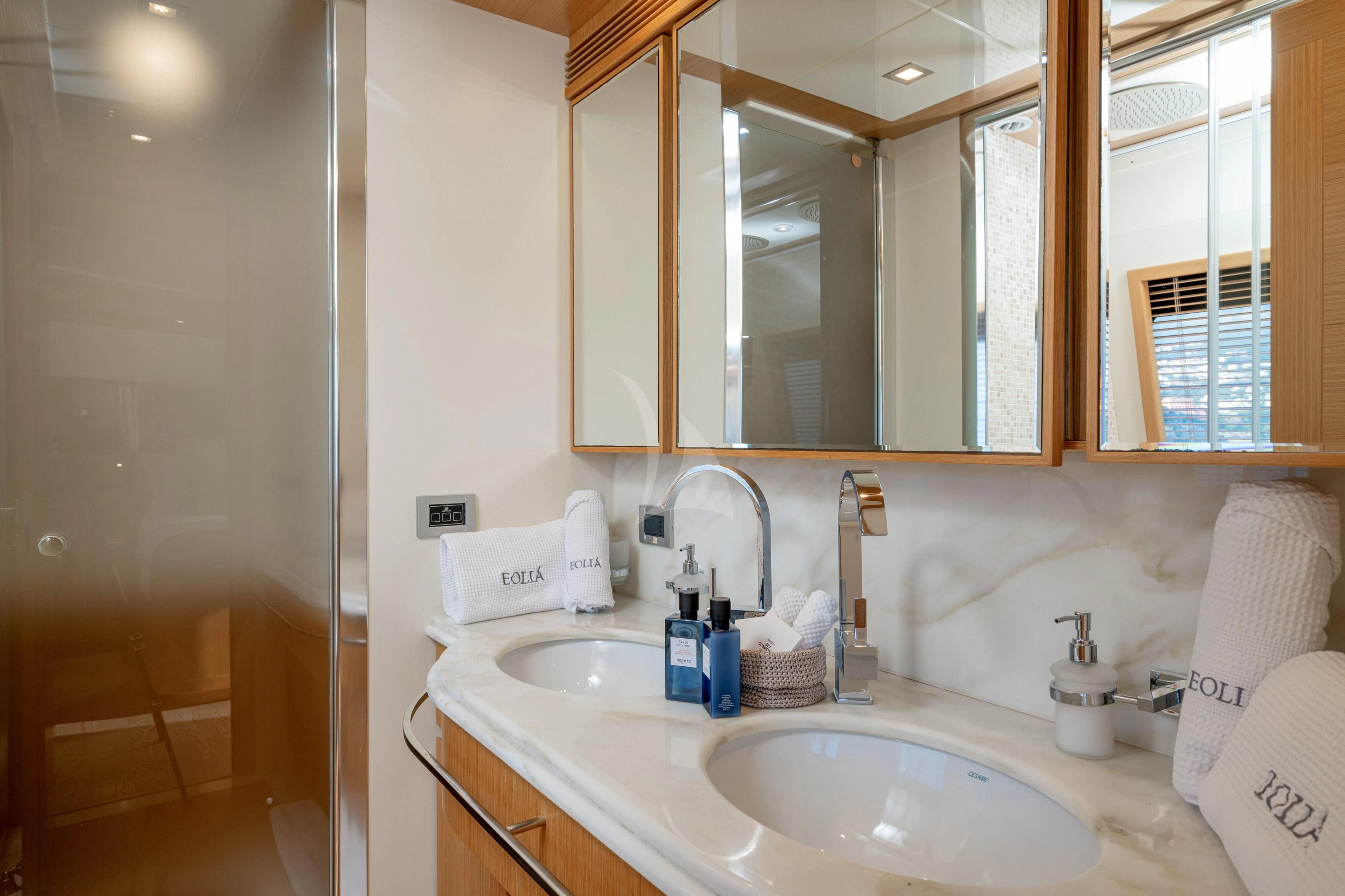 a bathroom with a sink and mirror aboard EOLIA Yacht for Sale