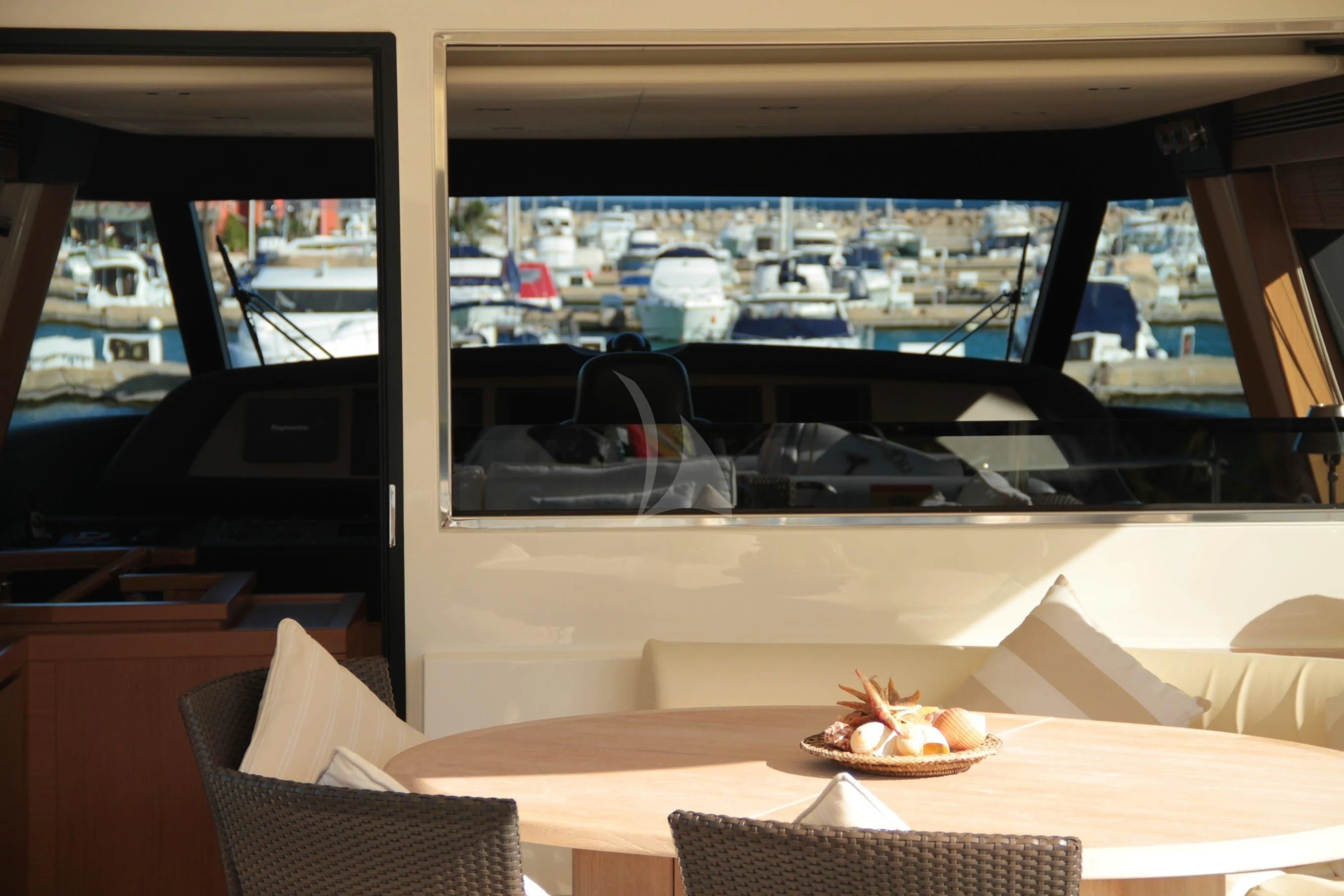 a room with a table and chairs aboard EOLIA Yacht for Sale