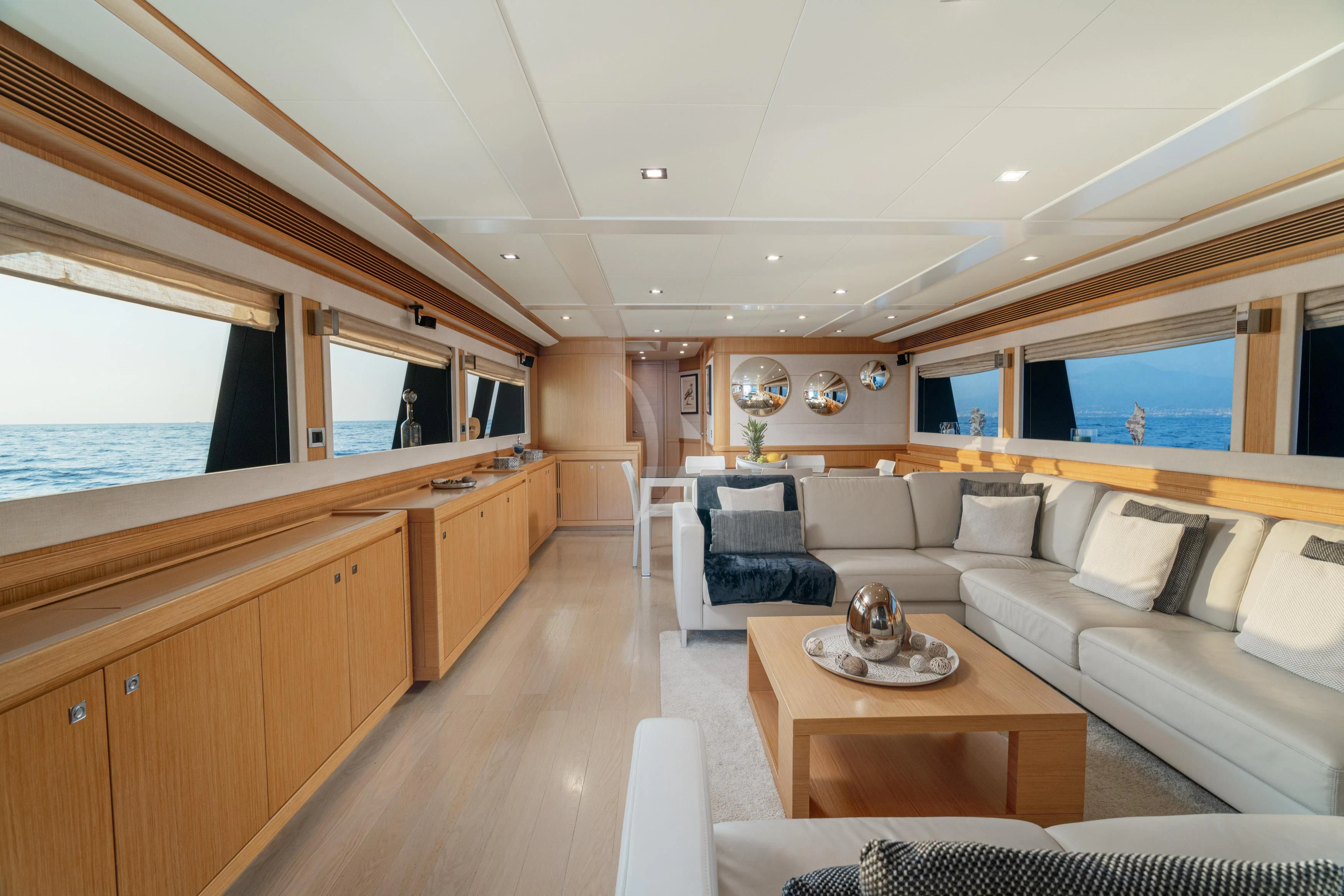 a living room with a wood floor aboard EOLIA Yacht for Sale