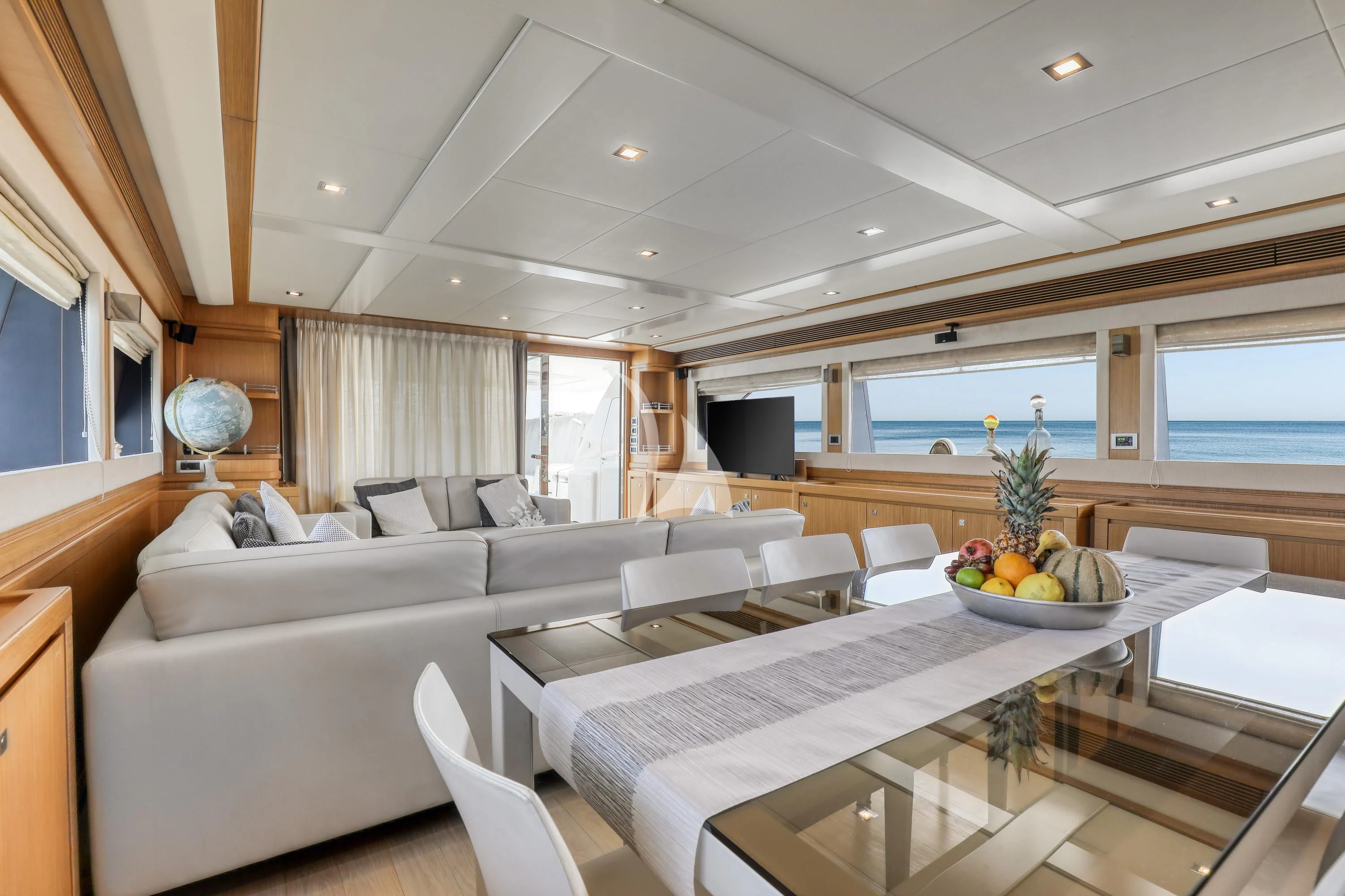 a large living room with a large white table and couches aboard EOLIA Yacht for Sale