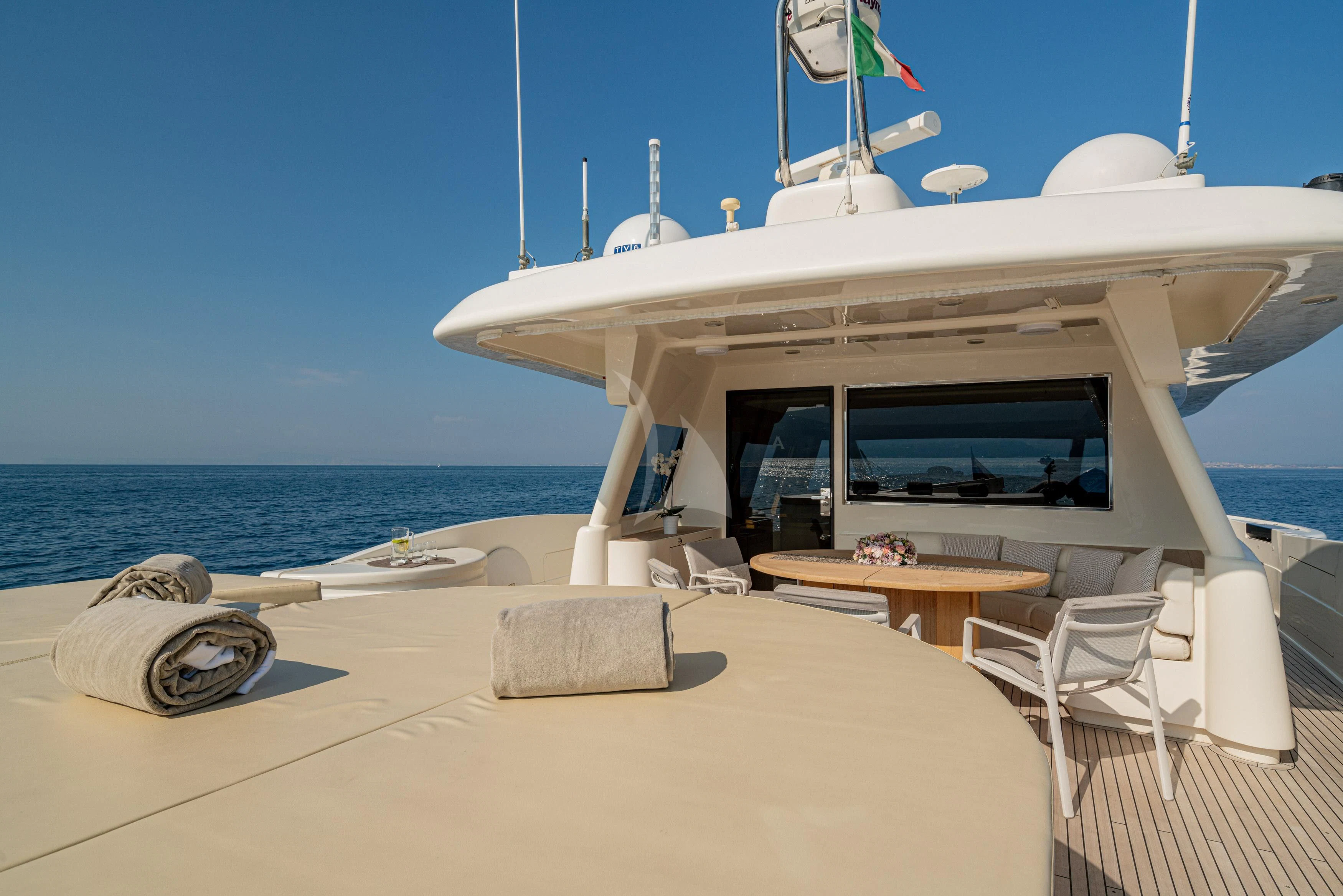 a white boat on a beach aboard EOLIA Yacht for Sale