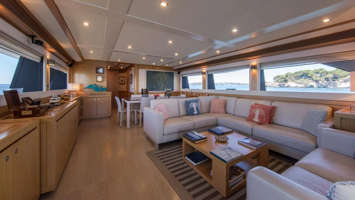 a living room with a couch and a table aboard EOLIA Yacht for Sale