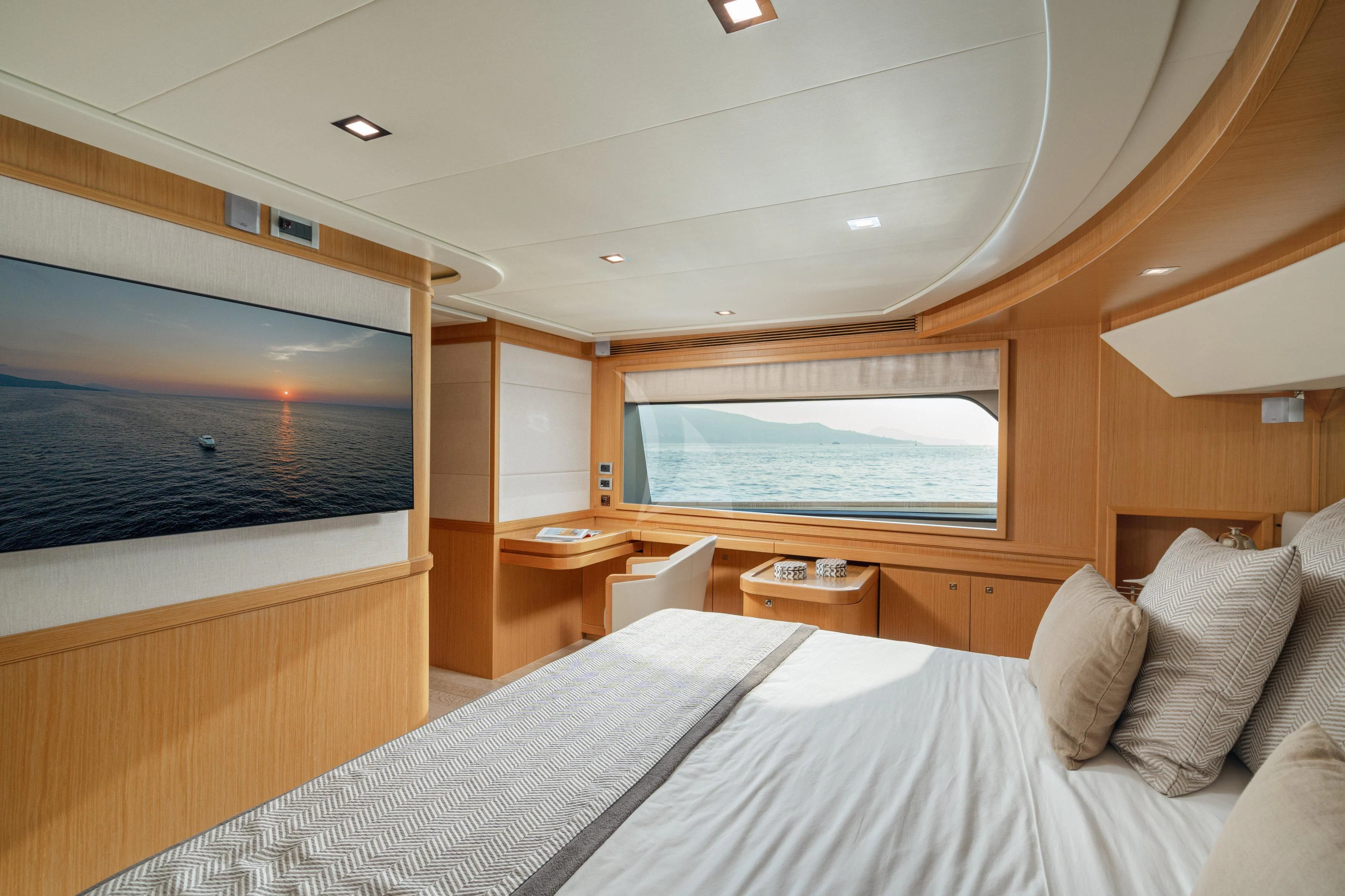 a room with a bed and a tv on the wall aboard EOLIA Yacht for Sale