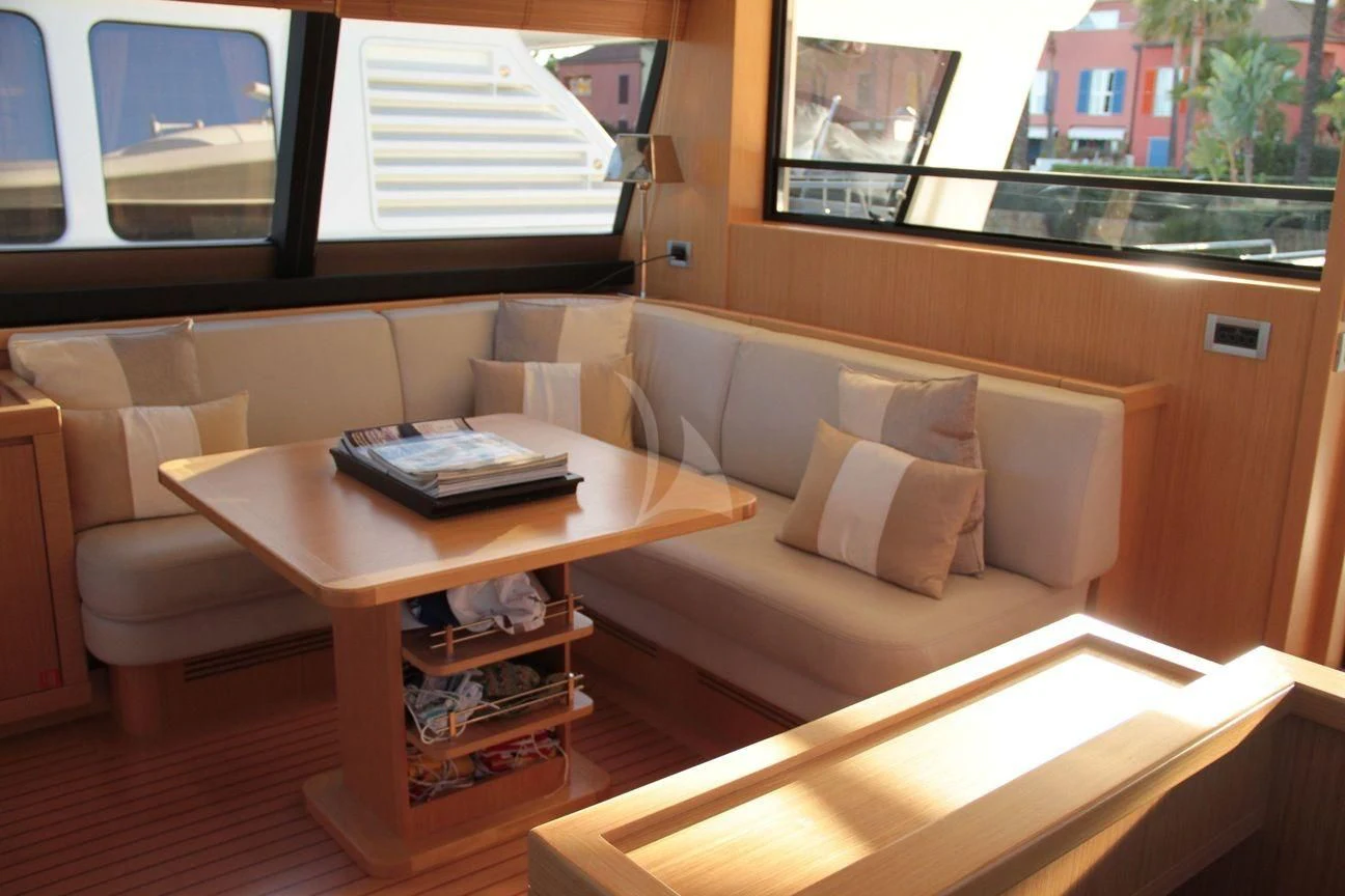 a living room with a couch and a coffee table aboard EOLIA Yacht for Sale